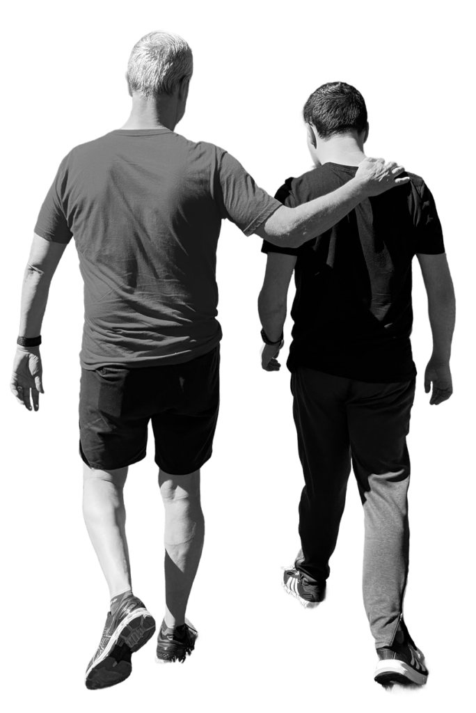 J Brad with his arm around Sam as they walk, symbolizing the shared path of autism advocacy and family support.